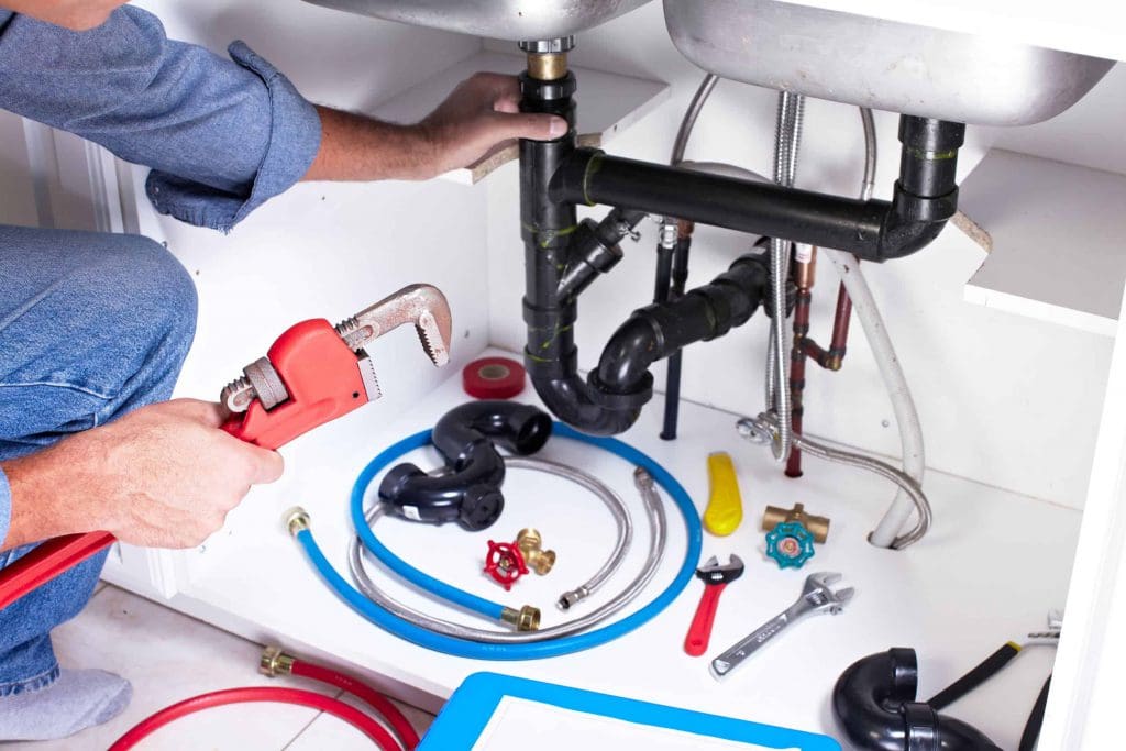 plumber working on a sink